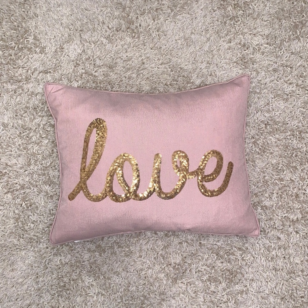 Pink pillow that says love